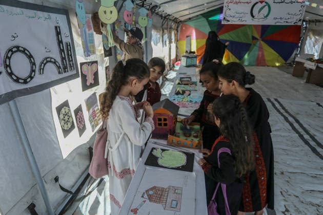 Palestinian children reflect war, displacement and hope through Art in Khan Yunis KHAN YUNIS, GAZA , PALESTINE - AUGUST 13: Works by Palestinian children are brought together in the exhibition held inside a tent at a refugee camp in the Al-Mawasi area of Khan Yunis, Gaza, Palestine on August 13, 2026. Created amid the severe humanitarian conditions resulting from the attacks that have continued since Oct. 2023, the artworks depict the children s experiences of displacement, destruction, hunger, water shortages and the loss of loved ones. Abed Rahim Khatib Anadolu Han Yunus Palestinian Territory, Occupied. Editorial use only. Please get in touch for any other usage.  Copyright: x2026xAnadoluxAbedxRahimxKhatibx