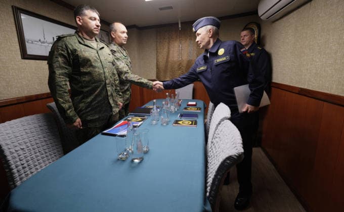 August 13, 2026, Korsakov, Sakhalin Oblast, Russia: Russian President Vladimir Putin, greets participants in a meeting on border security for the Far East, aboard the Russian Navy Slava-class missile cruiser RF Varyag, August 13, 2026 off the coast of Sakhalin Island, Russia. standing from left: Sakhalin Region FSB Border Guard Service Head Sergey Makhorin, 68th Guards Army Corps Acting Commander Alexey Shvedov, Putin, and Pacific Fleet Commander-in-Chief Admiral Viktor Liina. Korsakov Russia - ZUMAp138 20260813_zaa_p138_008 Copyright: xGavriilxGrigorov RussianxGovernmx