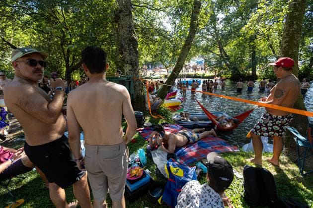 Couraíso - The River at Vodafone Paredes de Coura 2026 in Portugal - 13 Aug Festivalgoers rest and gather by the river Coura known locally as Couraíso during the daytime at Vodafone Paredes de Coura. Paredes de Coura Portugal Copyright: xDiogoxBaptistax xSOPAxImagesx DB_PDCRiver20260813PDC_008