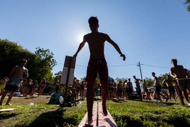 August 13, 2026, Paredes De Coura, Braga, Portugal: A festivalgoer balances on a board at the river Coura known locally as Couraiso during the daytime at Vodafone Paredes de Coura. Paredes De Coura Portugal - ZUMAs197 20260813_aab_s197_019 Copyright: xDiogoxBaptistax