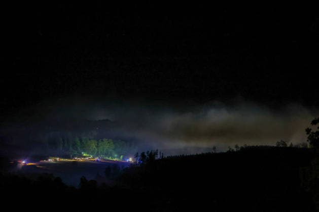 Helminghausen, Marsberg, Nordrhein-Westfalen, Deutschland, Europa: Dichter Rauch steigt während eines nächtlichen Waldbrandeinsatzes nahe der Diemeltalsperre über das Waldgebiet auf. Feuerwehrfahrzeuge und Einsatzkräfte arbeiten entlang des Waldrandes, während Scheinwerfer und Blaulicht die großflächige Einsatzstelle ausleuchten. *** Helminghausen, Marsberg, North Rhine-Westphalia, Germany, Europe: Thick smoke rises above the forest during a nighttime wildfire operation near the Diemel Dam; fire trucks and emergency personnel are working along the edge of the forest, while spotlights and blue lights illuminate the extensive scene of the operation Copyright: xAymanxAlahmedx