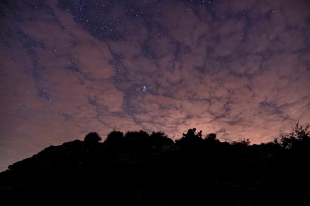 Perseid Meteor Shower Over Izmir Silhouettes of skywatchers gather on a ridge beneath a partly cloudy, star-filled sky near Sarpincik Lighthouse in Karaburun district of Izmir, Turkey, on August 13, 2026. The annual Perseid meteor shower, produced as Earth passes through debris left by comet Swift-Tuttle, peaked overnight from August 12 into the early hours of August 13, drawing skywatchers to dark viewing points to observe one of the year™s best-known meteor displays. Izmir Izmir Turkey Copyright: xMuratxKocabasx