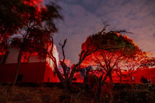 Perseid Meteor Shower Over Izmir Trees and a small building near Sarpincik Lighthouse are illuminated in red beneath a partly cloudy night sky in Karaburun district of Izmir, Turkey, on August 13, 2026. The annual Perseid meteor shower, produced as Earth passes through debris left by comet Swift-Tuttle, peaked overnight from August 12 into the early hours of August 13, drawing skywatchers to dark viewing points to observe one of the year™s best-known meteor displays. Izmir Izmir Turkey Copyright: xMuratxKocabasx