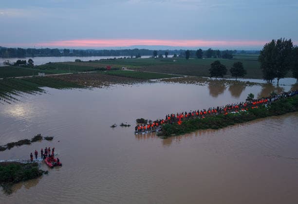 (260814) -- JIAXIAN, Aug. 14, 2026 -- An aerial drone photo shows repair work underway at the site of a levee breach along the Beiru River in Jiaxian County, central China s Henan Province, Aug. 13, 2026. A levee along the Beiru River in Jiaxian County gave way on Wednesday night, following extreme rainfall and large-volume discharges from upstream reservoirs. As of Thursday, a total of 2,182 people had been evacuated to safety, with no casualties reported so far. Efforts to contain the levee breach are underway. ) CHINA-HENAN-JIAXIAN COUNTY-LEVEE BREACH-REPAIR WORK (CN) HaoxYuan 