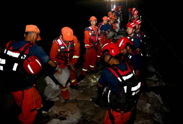 (260814) -- JIAXIAN, Aug. 14, 2026 -- Rescuers work at the site of a levee breach along the Beiru River in Jiaxian County, central China s Henan Province, Aug. 13, 2026. A levee along the Beiru River in Jiaxian County gave way on Wednesday night, following extreme rainfall and large-volume discharges from upstream reservoirs. As of Thursday, a total of 2,182 people had been evacuated to safety, with no casualties reported so far. Efforts to contain the levee breach are underway. ) CHINA-HENAN-JIAXIAN COUNTY-LEVEE BREACH-REPAIR WORK (CN) HaoxYuan 