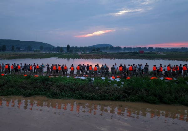 (260814) -- JIAXIAN, Aug. 14, 2026 -- An aerial drone photo shows repair work underway at the site of a levee breach along the Beiru River in Jiaxian County, central China s Henan Province, Aug. 13, 2026. A levee along the Beiru River in Jiaxian County gave way on Wednesday night, following extreme rainfall and large-volume discharges from upstream reservoirs. As of Thursday, a total of 2,182 people had been evacuated to safety, with no casualties reported so far. Efforts to contain the levee breach are underway. ) CHINA-HENAN-JIAXIAN COUNTY-LEVEE BREACH-REPAIR WORK (CN) HaoxYuan 