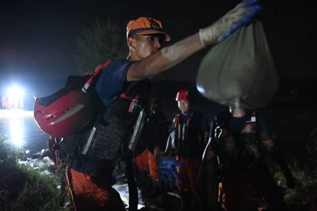 (260814) -- JIAXIAN, Aug. 14, 2026 -- Rescuers work at the site of a levee breach along the Beiru River in Jiaxian County, central China s Henan Province, Aug. 13, 2026. A levee along the Beiru River in Jiaxian County gave way on Wednesday night, following extreme rainfall and large-volume discharges from upstream reservoirs. As of Thursday, a total of 2,182 people had been evacuated to safety, with no casualties reported so far. Efforts to contain the levee breach are underway. (Photo by Xinhua) CHINA-HENAN-JIAXIAN COUNTY-LEVEE BREACH-REPAIR WORK (CN) KongxWeijia 