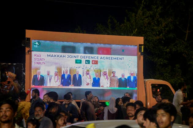 Pakistan Independence Day Celebrations Rawalpindi People gather near a digital screen displaying a Makkah Joint Defence Agreement message on Liaquat Bagh Road in Rawalpindi, Pakistan, on August 14, 2026. Pakistan marks Independence Day on August 14, commemorating the countryis independence from British rule in 1947. Rawalpindi Punjab Pakistan Copyright: xZubairxAbbasix