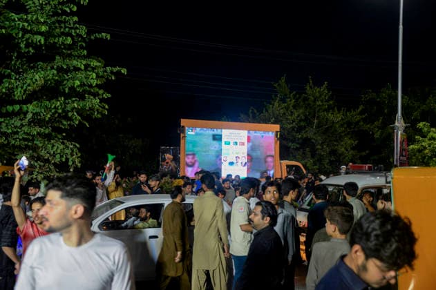 Pakistan Independence Day Celebrations Rawalpindi People gather near vehicles and a large digital screen during Independence Day celebrations in Rawalpindi, Pakistan, on August 14, 2026. Pakistan marks Independence Day on August 14, commemorating the countryis independence from British rule in 1947. Rawalpindi Punjab Pakistan Copyright: xZubairxAbbasix