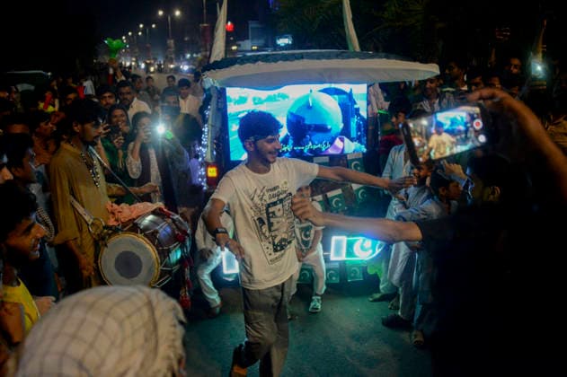 Pakistan Independence Day Celebrations Rawalpindi A man gestures beside a small vehicle as people gather during Independence Day celebrations in Rawalpindi, Pakistan, on August 14, 2026. Pakistan marks Independence Day on August 14, commemorating the countryis independence from British rule in 1947. Rawalpindi Punjab Pakistan Copyright: xZubairxAbbasix