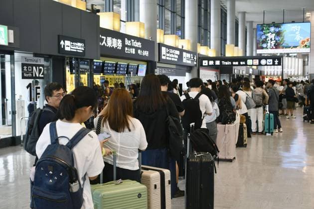 Aftermath of torrential rain in eastern Japan Travelers stand in long lines to board public transportation at Narita airport in Chiba Prefecture, east of Tokyo, on Aug. 14, 2026, after being stranded there overnight by torrential rain. Japan s weather agency issued its highest Level 5 warning for downpours in parts of the prefecture.  A14AA0005625753P