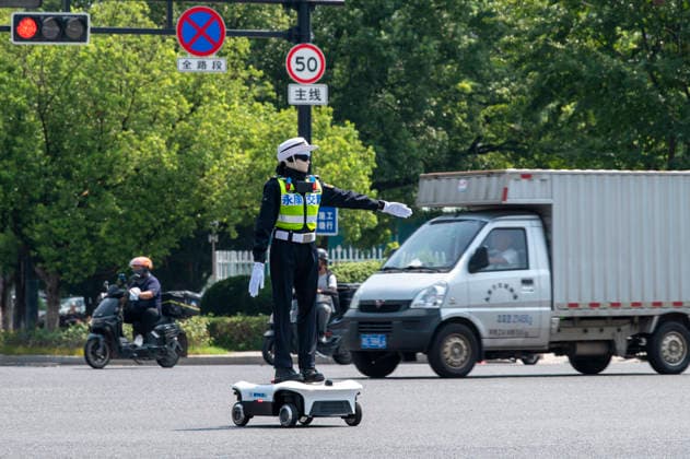 YONGKANG, CHINA - AUGUST 14: A robot traffic police officer assists in directing traffic at an intersection on August 14, 2026 in Yongkang, Jinhua, Zhejiang Province of China. Local authorities have launched a trial operation of robot traffic police to assist with road safety management.  Copyright: xVCGx 111659918422