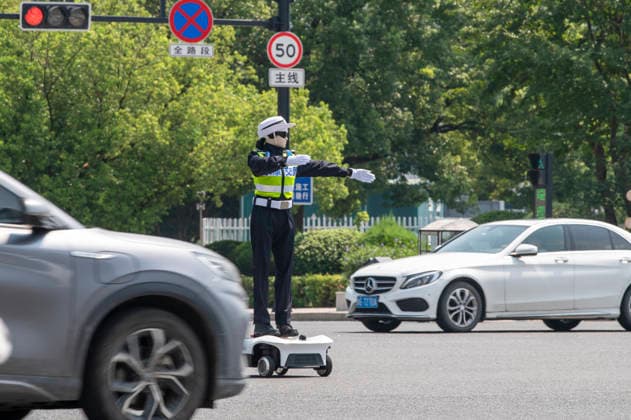 YONGKANG, CHINA - AUGUST 14: A robot traffic police officer assists in directing traffic at an intersection on August 14, 2026 in Yongkang, Jinhua, Zhejiang Province of China. Local authorities have launched a trial operation of robot traffic police to assist with road safety management.  Copyright: xVCGx 111659918423