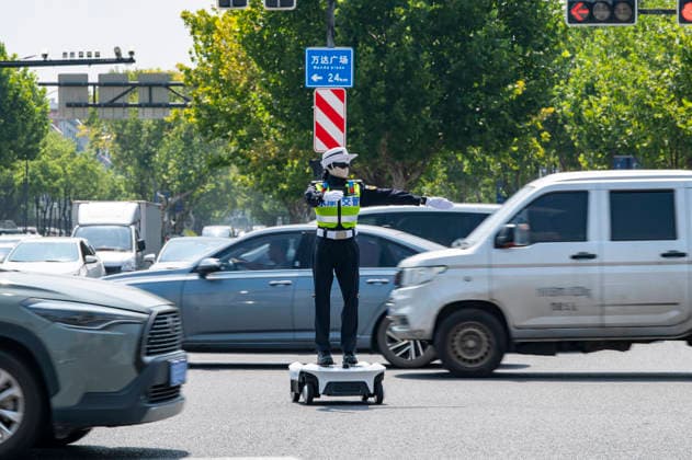 YONGKANG, CHINA - AUGUST 14: A robot traffic police officer assists in directing traffic at an intersection on August 14, 2026 in Yongkang, Jinhua, Zhejiang Province of China. Local authorities have launched a trial operation of robot traffic police to assist with road safety management.  Copyright: xVCGx 111659918428