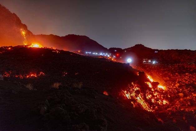 Mount Etna s eruptive activity continues CATANIA, ITALY - AUGUST 14: Mount Etna s eruptive activity continues, with active lava flows fed by vents located at 2,750 and 1,900 meters of altitude, alongside ongoing ash emissions from the Voragine summit crater in Catania, Sicily, Italy on August 14, 2026. The spectacular glowing lava streams have attracted an exceptional influx of hikers, tourists, and curious onlookers eager to witness the volcanic phenomenon at night. In response to this dangerous mass exodus towards the active lava fronts, local authorities have implemented strict roadblocks, parking bans along key mountain routes like the Mareneve road, and restricted access to the affected areas to ensure public safety. Meanwhile, the con  Copyright: x2026xAnadoluxSalvatorexAllegrax