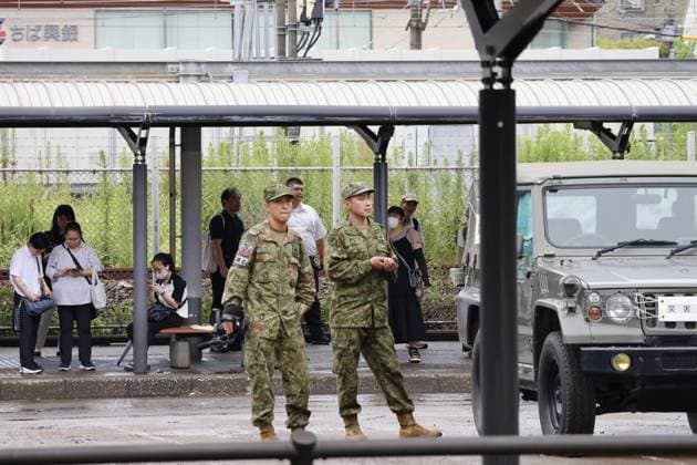 Aftermath of torrential rain in eastern Japan Japan Ground Self-Defense Force members are mobilized at JR Soga station in Chiba, east of Tokyo, on Aug. 14, 2026, to transport stranded people after railway operations were disrupted following torrential rain overnight.  A14AA0005625807P