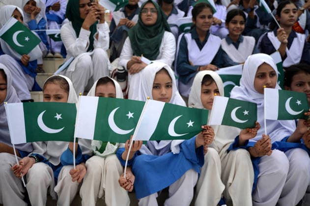 (260814) -- KARACHI, Aug. 14, 2026 -- Students wave Pakistani national flags during a ceremony to celebrate Pakistan s Independence Day in the southern Pakistani port city of Karachi on Aug. 14, 2026. (Str Xinhua) PAKISTAN-KARACHI-INDEPENDENCE DAY-CELEBRATIONS AhmadxKamal 
