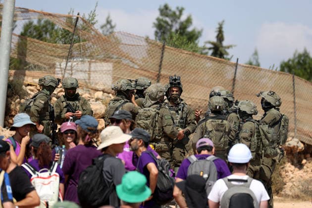 Activists attempt to deliver supplies to Palestinian families near Nablus NABLUS, WEST BANK, PALESTINE - AUGUST 14: Palestinian, Israeli and foreign activists attempt to deliver basic supplies to three Palestinian families living in the Ras al-Ayn area of Qusra, south of Nablus in the West Bank, Palestine, on August 14, 2026, as Israelis have blocked roads leading to the families’ homes since August 9, restricting access to and from the area in the presence of Israeli soldiers, with the restrictions remaining in place. Issam Rimawi Anadolu Nablus West Bank. Editorial use only. Please get in touch for any other usage.  Copyright: x2026xAnadoluxIssamxRimawix