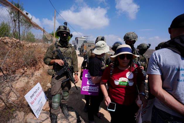 Activists attempt to deliver supplies to Palestinian families near Nablus NABLUS, WEST BANK, PALESTINE - AUGUST 14: Palestinian, Israeli and foreign activists attempt to deliver basic supplies to three Palestinian families living in the Ras al-Ayn area of Qusra, south of Nablus in the West Bank, Palestine, on August 14, 2026, as Israelis have blocked roads leading to the families’ homes since August 9, restricting access to and from the area in the presence of Israeli soldiers, with the restrictions remaining in place. Issam Rimawi Anadolu Nablus West Bank. Editorial use only. Please get in touch for any other usage.  Copyright: x2026xAnadoluxIssamxRimawix