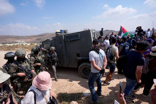 Activists attempt to deliver supplies to Palestinian families near Nablus NABLUS, WEST BANK, PALESTINE - AUGUST 14: Palestinian, Israeli and foreign activists attempt to deliver basic supplies to three Palestinian families living in the Ras al-Ayn area of Qusra, south of Nablus in the West Bank, Palestine, on August 14, 2026, as Israelis have blocked roads leading to the families’ homes since August 9, restricting access to and from the area in the presence of Israeli soldiers, with the restrictions remaining in place. Issam Rimawi Anadolu Nablus West Bank. Editorial use only. Please get in touch for any other usage.  Copyright: x2026xAnadoluxIssamxRimawix
