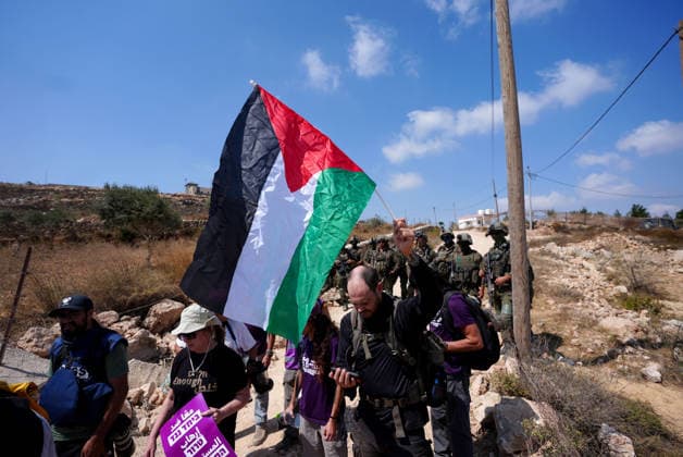 Activists attempt to deliver supplies to Palestinian families near Nablus NABLUS, WEST BANK, PALESTINE - AUGUST 14: Palestinian, Israeli and foreign activists attempt to deliver basic supplies to three Palestinian families living in the Ras al-Ayn area of Qusra, south of Nablus in the West Bank, Palestine, on August 14, 2026, as Israelis have blocked roads leading to the families’ homes since August 9, restricting access to and from the area in the presence of Israeli soldiers, with the restrictions remaining in place. Issam Rimawi Anadolu Nablus West Bank. Editorial use only. Please get in touch for any other usage.  Copyright: x2026xAnadoluxIssamxRimawix