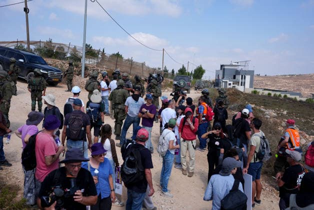 Activists attempt to deliver supplies to Palestinian families near Nablus NABLUS, WEST BANK, PALESTINE - AUGUST 14: Palestinian, Israeli and foreign activists attempt to deliver basic supplies to three Palestinian families living in the Ras al-Ayn area of Qusra, south of Nablus in the West Bank, Palestine, on August 14, 2026, as Israelis have blocked roads leading to the families’ homes since August 9, restricting access to and from the area in the presence of Israeli soldiers, with the restrictions remaining in place. Issam Rimawi Anadolu Nablus West Bank. Editorial use only. Please get in touch for any other usage.  Copyright: x2026xAnadoluxIssamxRimawix