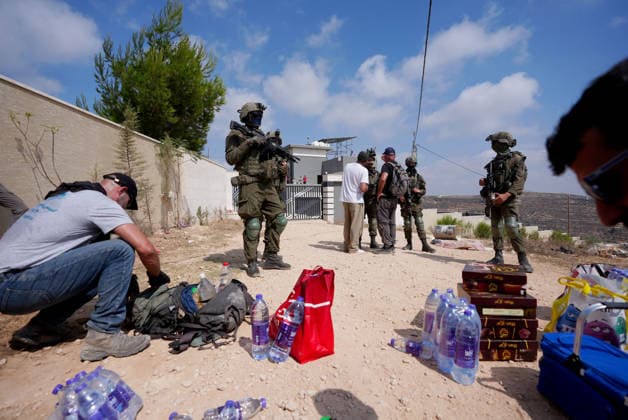 Activists attempt to deliver supplies to Palestinian families near Nablus NABLUS, WEST BANK, PALESTINE - AUGUST 14: Palestinian, Israeli and foreign activists attempt to deliver basic supplies to three Palestinian families living in the Ras al-Ayn area of Qusra, south of Nablus in the West Bank, Palestine, on August 14, 2026, as Israelis have blocked roads leading to the families’ homes since August 9, restricting access to and from the area in the presence of Israeli soldiers, with the restrictions remaining in place. Issam Rimawi Anadolu Nablus West Bank. Editorial use only. Please get in touch for any other usage.  Copyright: x2026xAnadoluxIssamxRimawix