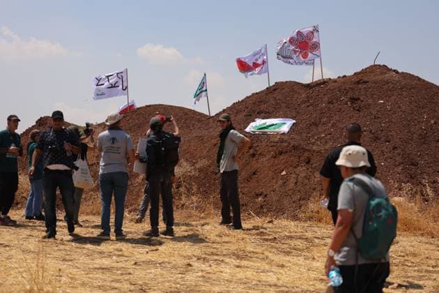 Activists remove Israeli flags from Palestinian home in Beit Sahour BEIT SAHOUR, WEST BANK, PALESTINE, AUGUST 14, 2026: Palestinian and Israeli activists remove an Israeli Star of David and Israeli flags from a Palestinian home in Beit Sahour, east of Bethlehem. The activists said the flags and emblem had been placed on the house by Israeli settlers since October 7, 2023, in what they described as an attempt to take control of the property. According to the activists, settlers arrived at the site as the flags were being removed and opened fire in their direction. No injuries were reported. BEIT SAHOUR Palestine, State of Copyright: x xMosabxshawerx xJNAxPressx