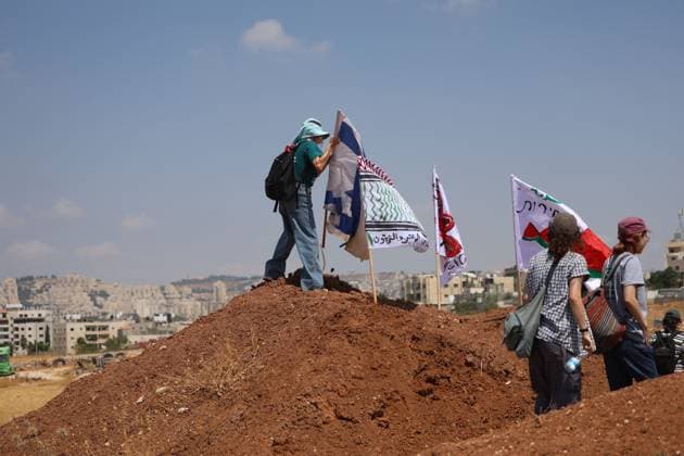 Activists remove Israeli flags from Palestinian home in Beit Sahour BEIT SAHOUR, WEST BANK, PALESTINE, AUGUST 14, 2026: Palestinian and Israeli activists remove an Israeli Star of David and Israeli flags from a Palestinian home in Beit Sahour, east of Bethlehem. The activists said the flags and emblem had been placed on the house by Israeli settlers since October 7, 2023, in what they described as an attempt to take control of the property. According to the activists, settlers arrived at the site as the flags were being removed and opened fire in their direction. No injuries were reported. BEIT SAHOUR Palestine, State of Copyright: x xMosabxshawerx xJNAxPressx