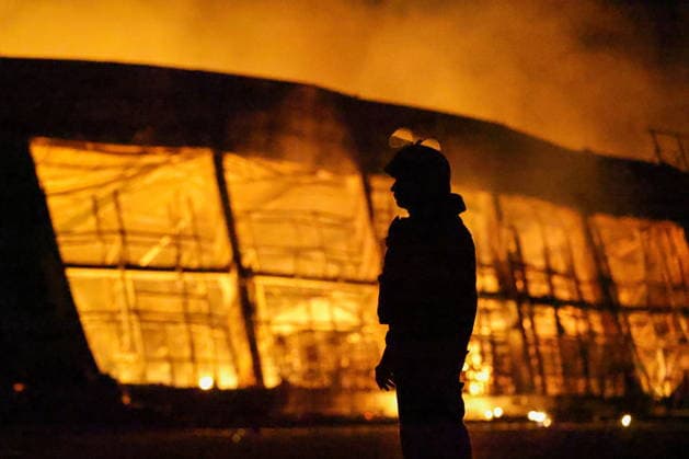 RUSSIA, DONETSK PEOPLE S REPUBLIC - AUGUST 14, 2026: An emergency worker battles a fire caused by a Ukrainian drone strike on the Galaktika Galaxy shopping centre in Yenakiyevo, northeast of Donetsk. Dmitry Yagodkin TASS  96146266