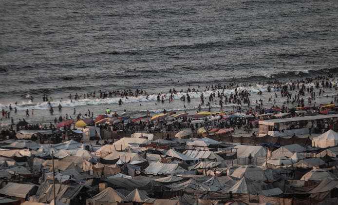 Daily life in Gaza amid the ongoing Israeli attacks despite ceasefire GAZA CITY, GAZA, PALESTINE - AUGUST 14: Displaced Palestinians living along the coastal strip of blockaded Gaza City carry out daily activities among the ruins of destroyed buildings during sunset in Gaza, Palestine on August 14, 2026. Deprived of basic necessities following Israeli attacks, families struggle to survive in makeshift tents pitched near the rubble of their homes and inside heavily damaged structures under severe conditions. Ali Jadallah Anadolu Gaza City Gaza. Editorial use only. Please get in touch for any other usage.  Copyright: x2026xAnadoluxAlixJadallahx