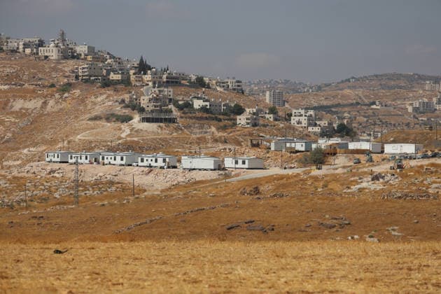 Activists Remove Flags From Beit Sahour A landscape view shows houses and dry hills in Beit Sahour, east of Bethlehem in the occupied West Bank, on August 14, 2026. The activists said settlers had placed the symbols on the house after October 7, 2023, in what they described as an attempt to seize control of the property, and that settlers opened fire toward them as the items were removed, with no injuries reported. Bethlehem West Bank Palestinian Territories Copyright: xMosabxShawerx