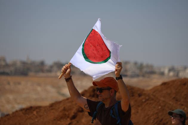 Activists Remove Flags From Beit Sahour An activist raises a flag bearing a watermelon motif in Beit Sahour, east of Bethlehem in the occupied West Bank, on August 14, 2026. The activists said settlers had placed the symbols on the house after October 7, 2023, in what they described as an attempt to seize control of the property, and that settlers opened fire toward them as the items were removed, with no injuries reported. Bethlehem West Bank Palestinian Territories Copyright: xMosabxShawerx