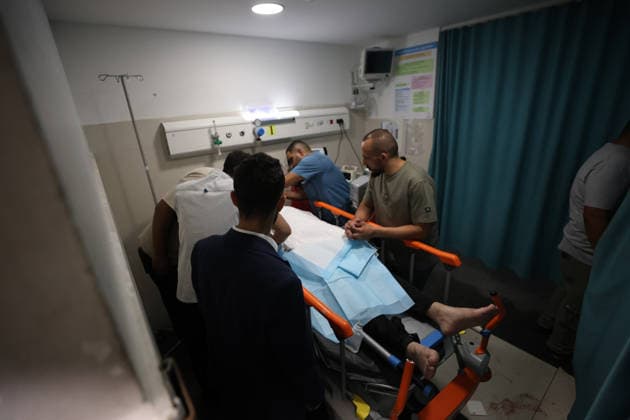 Sair Settler Attack Injures Palestinians Medical workers surround an injured Palestinian on a stretcher in a hospital treatment room after an attack in Sa™ir, east of Hebron in the occupied West Bank, on August 14, 2026. The three Palestinians were wounded when settlers opened fire during the attack on the town, according to information provided by the photographer. Hebron West Bank Palestinian Territories Copyright: xMosabxShawerx