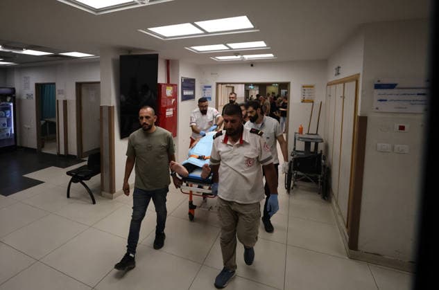 Sair Settler Attack Injures Palestinians Palestinian Red Crescent medics move an injured Palestinian on a stretcher through a hospital corridor after an attack in Sa™ir, east of Hebron in the occupied West Bank, on August 14, 2026. The three Palestinians were wounded when settlers opened fire during the attack on the town, according to information provided by the photographer. Hebron West Bank Palestinian Territories Copyright: xMosabxShawerx