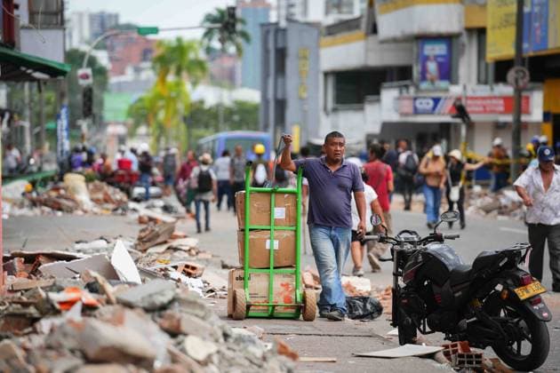 (260815) -- PEREIRA, Aug. 15, 2026 -- A man pulls a hand trolley loaded with cardboard boxes after an earthquake in Pereira, Colombia on Aug. 14, 2026. A 7.4-magnitude earthquake jolted western Colombia on Monday. (Photo by Xinhua) COLOMBIA-PEREIRA-EARTHQUAKE-AFTERMATH AndresxMoreno 