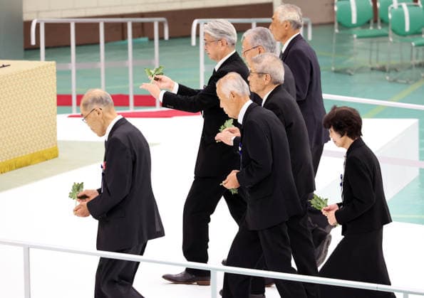 August 15, 2026, Tokyo, Japan - Relatives of war dead offer chrysanthemums on an altar at the memorial service for the war dead at the Nippon Budokan hall in Tokyo on Saturday, August 15, 2026. Japan marked the 81st anniversary of its surrender of World War II. (photo by Yoshio Tsunoda AFLO)  aflo_341018805