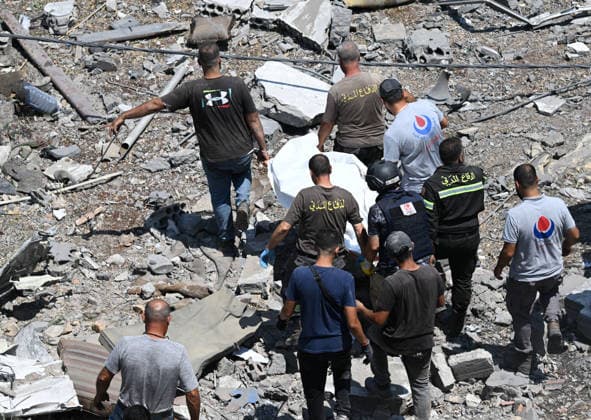 At least 11 killed in Israeli attack on southern Lebanon DEIR EZ-ZAHRANI, LEBANON - AUGUST 15: People carry a lifeless body pulled from the rubble as search and rescue efforts continue after the Israeli airstrike on Deir ez-Zahrani, where at least 11 people were killed, in Lebanon on August 15, 2026. Houssam Shbaro Anadolu Deir ez-Zahrani Lebanon. Editorial use only. Please get in touch for any other usage.  Copyright: x2026xAnadoluxHoussamxShbarox