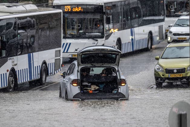 Flash floods submerge vehicles in East Jerusalem neighborhood following heavy rainfall EAST JERUSALEM - AUGUST 15: People wade through flooded roads and submerged vehicles are seen in the Wadi al-Joz neighborhood of East Jerusalem on August 15, 2026, after unseasonal heavy rainfall triggered localized flash flooding across the area. Search and rescue teams were dispatched to the district as rising waters trapped cars, disrupted traffic flow, and damaged infrastructure across low-lying urban streets. Mostafa Alkharouf Anadolu Jerusalem Israel. Editorial use only. Please get in touch for any other usage.  Copyright: x2026xAnadoluxMostafaxAlkharoufx