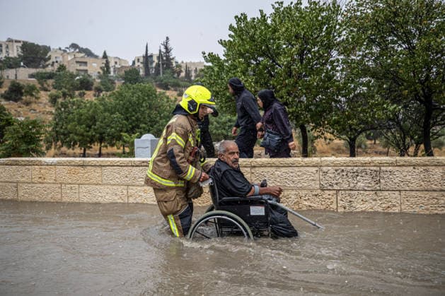 Flash floods submerge vehicles in East Jerusalem neighborhood following heavy rainfall EAST JERUSALEM - AUGUST 15: People wade through flooded roads and submerged vehicles are seen in the Wadi al-Joz neighborhood of East Jerusalem on August 15, 2026, after unseasonal heavy rainfall triggered localized flash flooding across the area. Search and rescue teams were dispatched to the district as rising waters trapped cars, disrupted traffic flow, and damaged infrastructure across low-lying urban streets. Mostafa Alkharouf Anadolu Jerusalem Israel. Editorial use only. Please get in touch for any other usage.  Copyright: x2026xAnadoluxMostafaxAlkharoufx