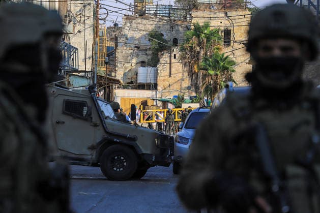 Israeli settlers raid historic Old City of Hebron in West Bank under military escort HEBRON, WEST BANK, PALESTINE - AUGUST 15: Israeli military personnel restrict the movement of local Palestinians during a raid by Israeli settlers in the Old City of Hebron, located in the southern West Bank, Palestine on August 15, 2026. Escorted by armed Israeli forces, the settlers entered the historic district while soldiers blocked key entry and exit points, severely limiting the daily mobility and access of Palestinian residents living in the area. Amer Shallodi Anadolu Hebron West Bank. Editorial use only. Please get in touch for any other usage.  Copyright: x2026xAnadoluxAmerxShallodix