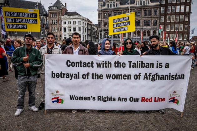 August 15, 2026, Amsterdam, North Holland, The Netherlands Holland: Demonstrators hold a banner reading Contact with the Taliban is a betrayal of the women of Afghanistan . August 15, 2026, Amsterdam, The Netherlands. Demonstrators gathered on Dam Square, Amsterdam, in solidarity with Afghan women and girls. The protest marked five years of Taliban rule and demanded access to education for women and girls be restored, and an end to Brussels engagement with the Taliban regime. Amsterdam The Netherlands Holland - ZUMAp202 20260815_zip_p202_004 Copyright: xJamesxPetermeierx