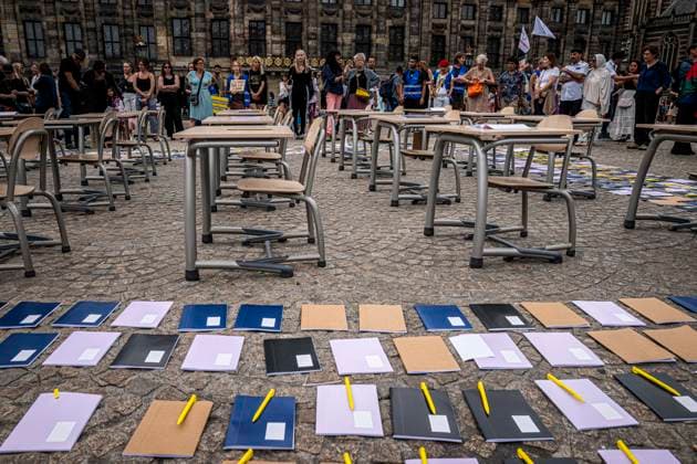 August 15, 2026, Amsterdam, North Holland, The Netherlands Holland: Notebooks and pens are set out as a call for education freedom in Afghanistan. August 15, 2026, Amsterdam, The Netherlands. Demonstrators gathered on Dam Square, Amsterdam, in solidarity with Afghan women and girls. The protest marked five years of Taliban rule and demanded access to education for women and girls be restored, and an end to Brussels engagement with the Taliban regime. Amsterdam The Netherlands Holland  - ZUMAp202 20260815_zip_p202_007 Copyright: xJamesxPetermeierx