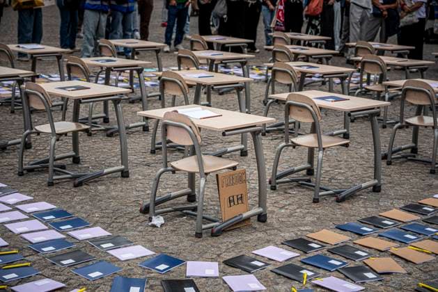 August 15, 2026, Amsterdam, North Holland, The Netherlands Holland: Notebooks and pens are set out as a call for education freedom in Afghanistan. August 15, 2026, Amsterdam, The Netherlands. Demonstrators gathered on Dam Square, Amsterdam, in solidarity with Afghan women and girls. The protest marked five years of Taliban rule and demanded access to education for women and girls be restored, and an end to Brussels engagement with the Taliban regime. Amsterdam The Netherlands Holland  - ZUMAp202 20260815_zip_p202_009 Copyright: xJamesxPetermeierx