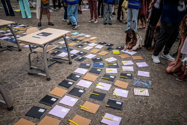 August 15, 2026, Amsterdam, North Holland, The Netherlands Holland: A young girl writes in a notebook that was laid out as a call for education freedom in Afghanistan. August 15, 2026, Amsterdam, The Netherlands. Demonstrators gathered on Dam Square, Amsterdam, in solidarity with Afghan women and girls. The protest marked five years of Taliban rule and demanded access to education for women and girls be restored, and an end to Brussels engagement with the Taliban regime. Amsterdam The Netherlands Holland  - ZUMAp202 20260815_zip_p202_011 Copyright: xJamesxPetermeierx