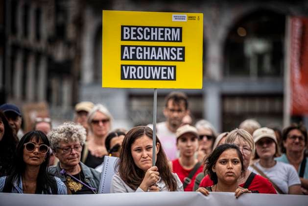 August 15, 2026, Amsterdam, North Holland, The Netherlands Holland: A demonstrator holds a sign reading Ã¢â‚¬oeProtect Afghan WomenÃ¢â‚¬Â (translated from Dutch). August 15, 2026, Amsterdam, The Netherlands. Demonstrators gathered on Dam Square, Amsterdam, in solidarity with Afghan women and girls. The protest marked five years of Taliban rule and demanded access to education for women and girls be restored, and an end to Brussels engagement with the Taliban regime. Amsterdam The Netherlands Holland  - ZUMAp202 20260815_zip_p202_014 Copyright: xJamesxPetermeierx