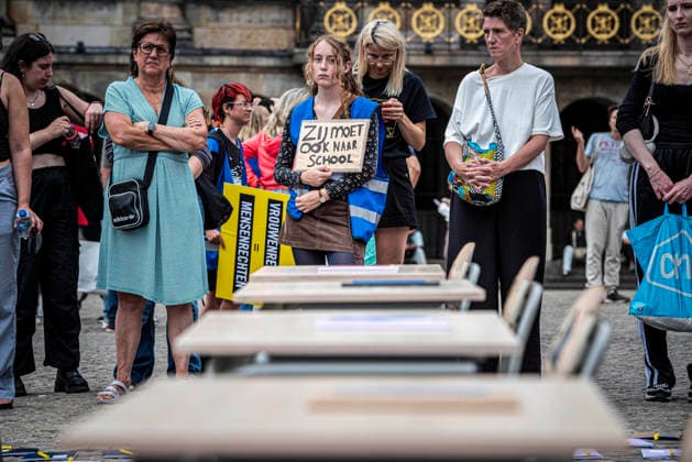 August 15, 2026, Amsterdam, North Holland, The Netherlands Holland: A demonstrator holds a sign reading Ã¢â‚¬oeShe also has to go to schoolÃ¢â‚¬Â (translated from Dutch). August 15, 2026, Amsterdam, The Netherlands. Demonstrators gathered on Dam Square, Amsterdam, in solidarity with Afghan women and girls. The protest marked five years of Taliban rule and demanded access to education for women and girls be restored, and an end to Brussels engagement with the Taliban regime. Amsterdam The Netherlands Holland  - ZUMAp202 20260815_zip_p202_016 Copyright: xJamesxPetermeierx