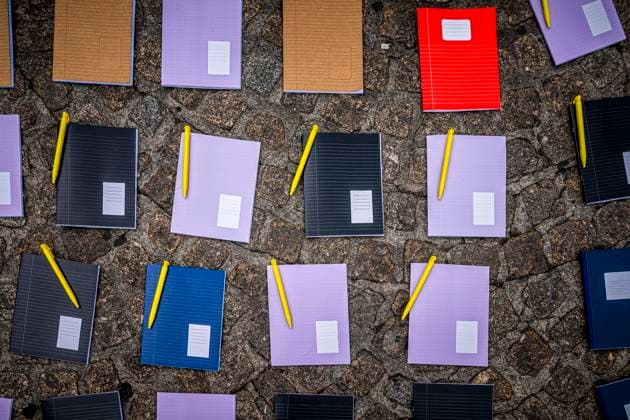 August 15, 2026, Amsterdam, North Holland, The Netherlands Holland: Notebooks and pens are set out as a call for education freedom in Afghanistan. August 15, 2026, Amsterdam, The Netherlands. Demonstrators gathered on Dam Square, Amsterdam, in solidarity with Afghan women and girls. The protest marked five years of Taliban rule and demanded access to education for women and girls be restored, and an end to Brussels engagement with the Taliban regime. Amsterdam The Netherlands Holland  - ZUMAp202 20260815_zip_p202_017 Copyright: xJamesxPetermeierx