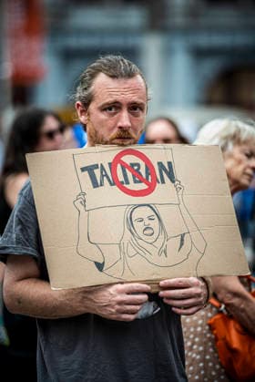 August 15, 2026, Amsterdam, North Holland, The Netherlands Holland: A demonstrator displays an anti-Taliban sign. August 15, 2026, Amsterdam, The Netherlands. Demonstrators gathered on Dam Square, Amsterdam, in solidarity with Afghan women and girls. The protest marked five years of Taliban rule and demanded access to education for women and girls be restored, and an end to Brussels engagement with the Taliban regime. Amsterdam The Netherlands Holland  - ZUMAp202 20260815_zip_p202_022 Copyright: xJamesxPetermeierx