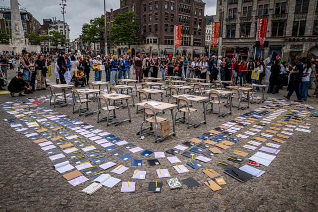 August 15, 2026, Amsterdam, North Holland, The Netherlands Holland: Notebooks and pens are set out as a call for education freedom in Afghanistan. August 15, 2026, Amsterdam, The Netherlands. Demonstrators gathered on Dam Square, Amsterdam, in solidarity with Afghan women and girls. The protest marked five years of Taliban rule and demanded access to education for women and girls be restored, and an end to Brussels engagement with the Taliban regime. Amsterdam The Netherlands Holland  - ZUMAp202 20260815_zip_p202_026 Copyright: xJamesxPetermeierx